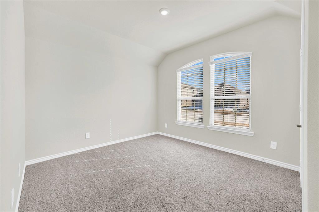 9713 Quail Pointe Road Aubrey, TX 76227 - Photo 2 of 23 Spare room featuring lofted ceiling, carpet floors, and recessed lighting