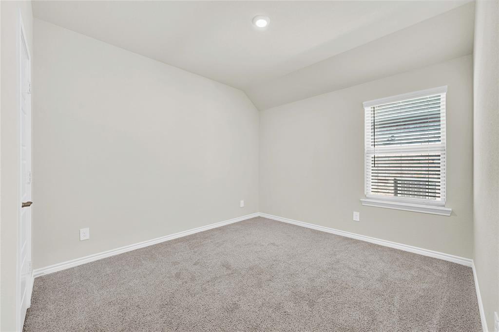 9713 Quail Pointe Road Aubrey, TX 76227 - Photo 4 of 23 Empty room with lofted ceiling and carpet flooring