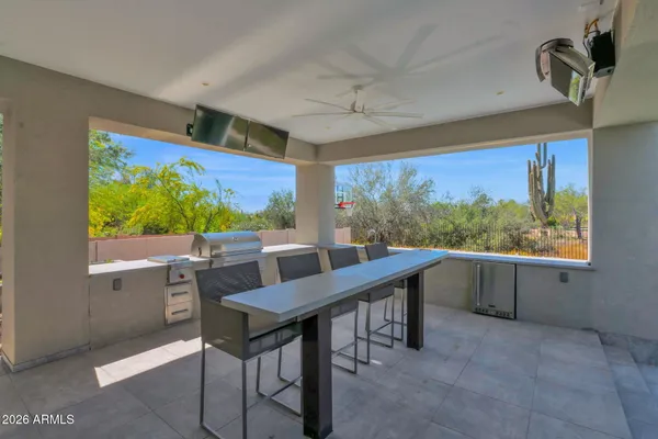 a living room with furniture a chandelier and a window
