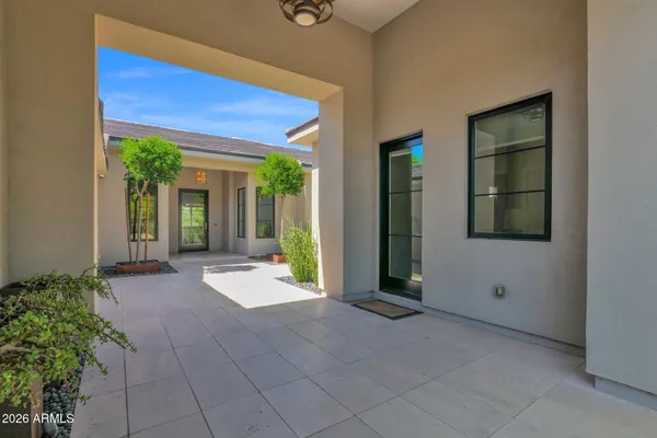 a view of a dining room with furniture a chandelier and wooden floor