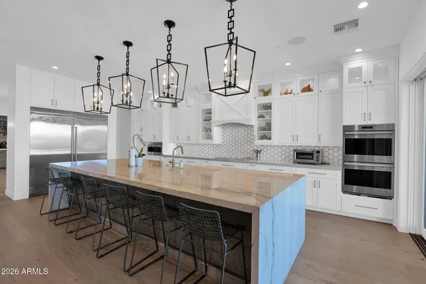 a spacious bedroom with a bed a couch and a potted plant