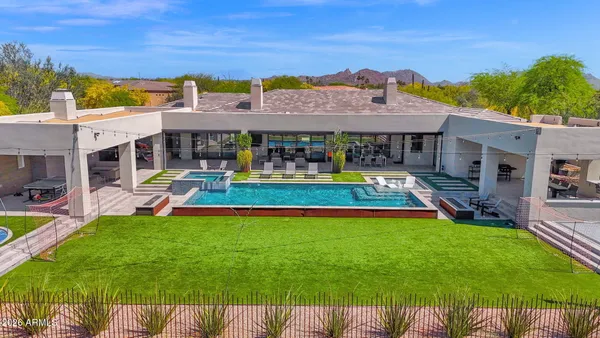 a bathroom with a tub sink and mirror