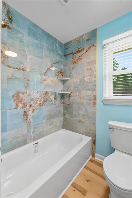 1745 Rockbridge Road Northwest Conyers, GA 30012 - Photo 18 of 32 a white bath tub sitting next to a white toilet