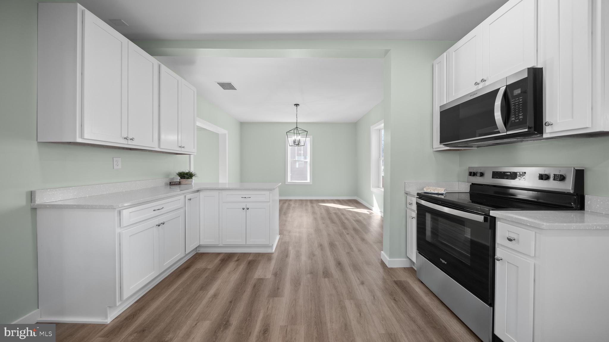 603 East Chestnut Street Delmar, MD 21875 - Photo 11 of 33 a kitchen with stainless steel appliances granite countertop wooden cabinets and a stove top oven