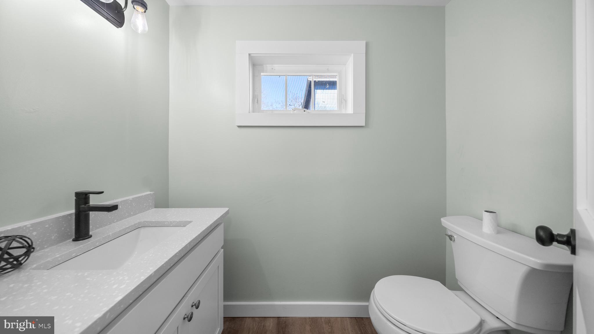 603 East Chestnut Street Delmar, MD 21875 - Photo 15 of 33 a bathroom with a toilet a sink and mirror