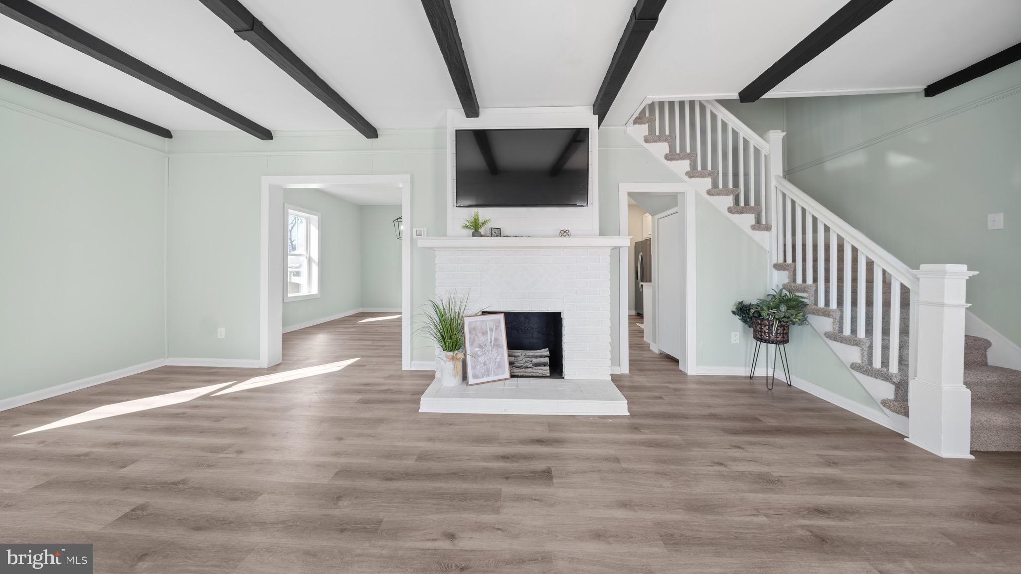603 East Chestnut Street Delmar, MD 21875 - Photo 2 of 33 a view of a livingroom with a fireplace and staircase