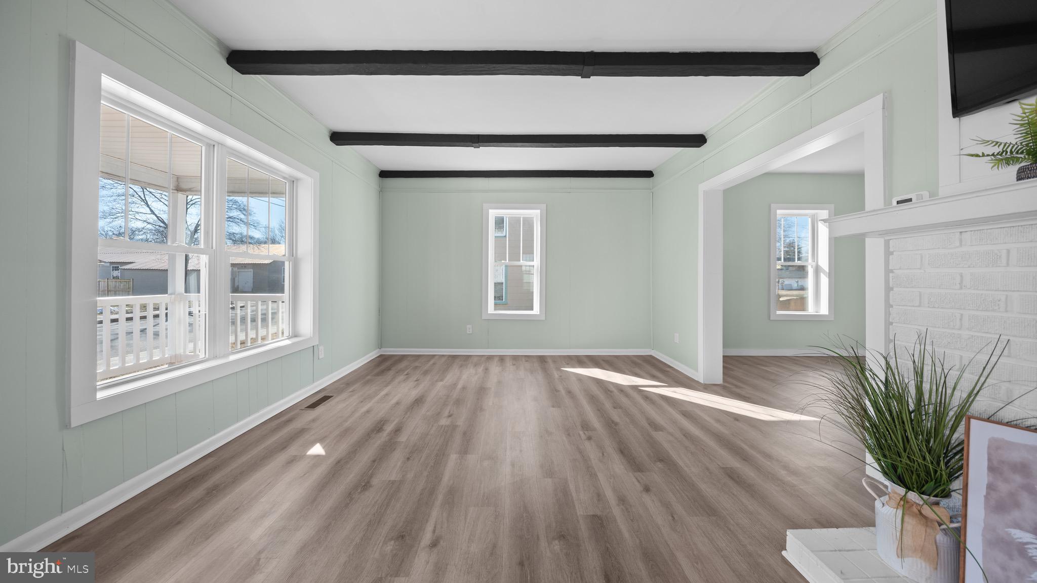 603 East Chestnut Street Delmar, MD 21875 - Photo 6 of 33 a view of an empty room with a window and wooden floor