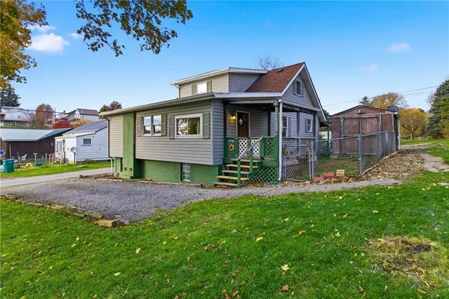 a view of an house with backyard space and balcony