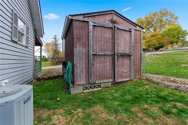 a view of a backyard with wooden fence