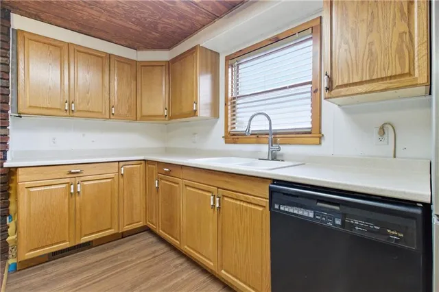 a kitchen with granite countertop cabinets stainless steel appliances and a sink