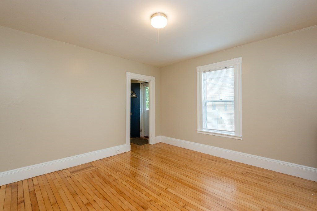 13 Melville Place Lynn, MA 01902 - Photo 20 of 41 an empty room with wooden floor and windows