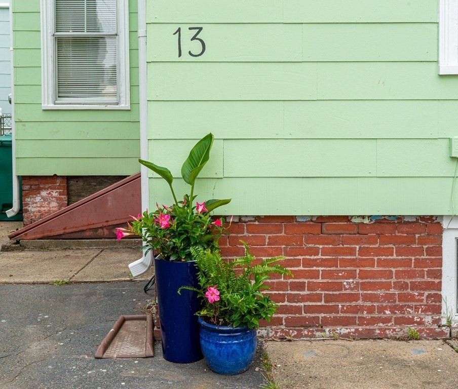 13 Melville Place Lynn, MA 01902 - Photo 2 of 41 a potted plant sitting in front of a house