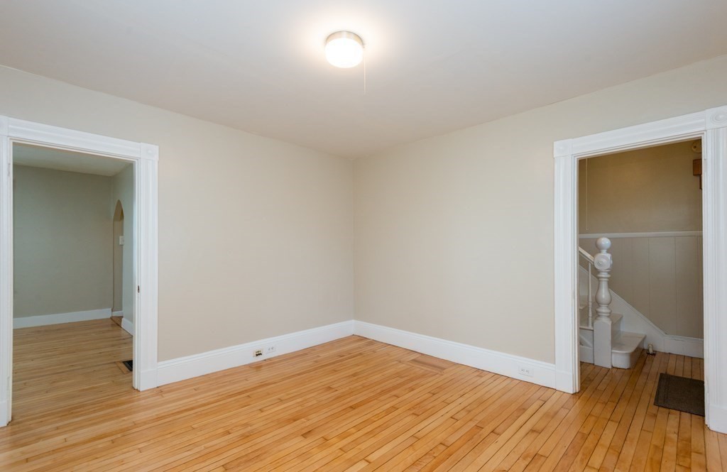 13 Melville Place Lynn, MA 01902 - Photo 21 of 41 an empty room with wooden floor and a window