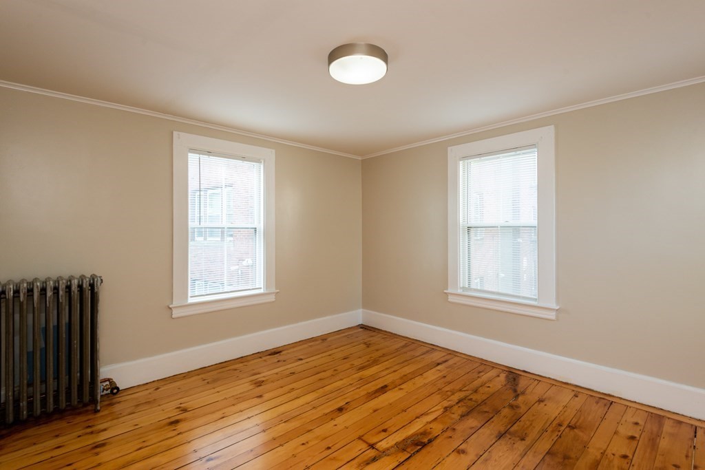 13 Melville Place Lynn, MA 01902 - Photo 23 of 41 an empty room with wooden floor and windows