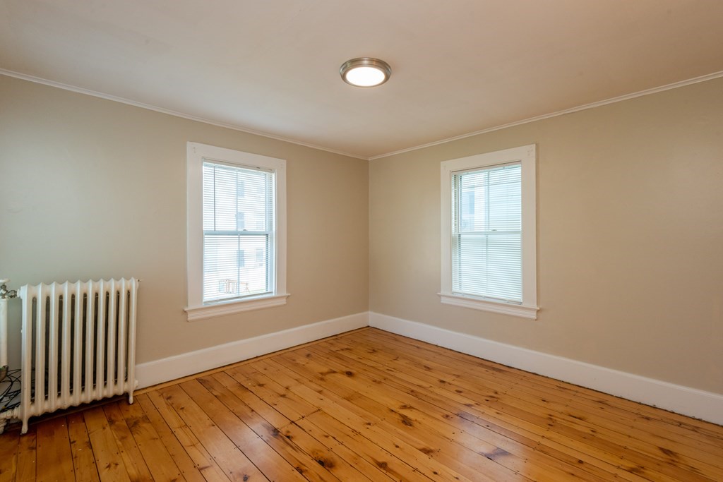 13 Melville Place Lynn, MA 01902 - Photo 28 of 41 an empty room with wooden floor and windows
