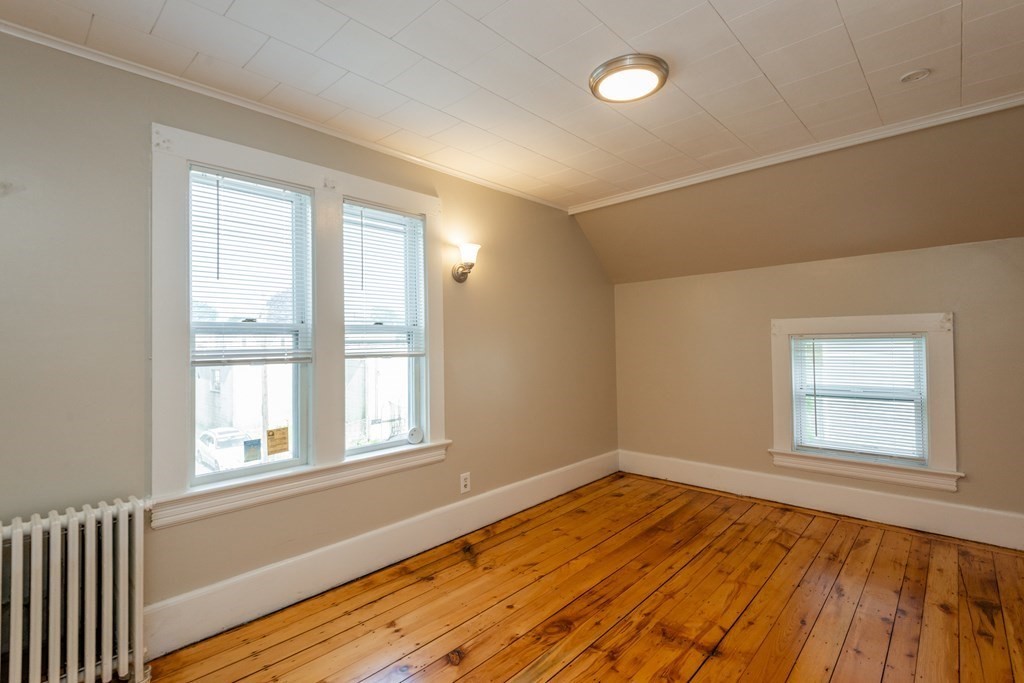 13 Melville Place Lynn, MA 01902 - Photo 31 of 41 an empty room with wooden floor and windows