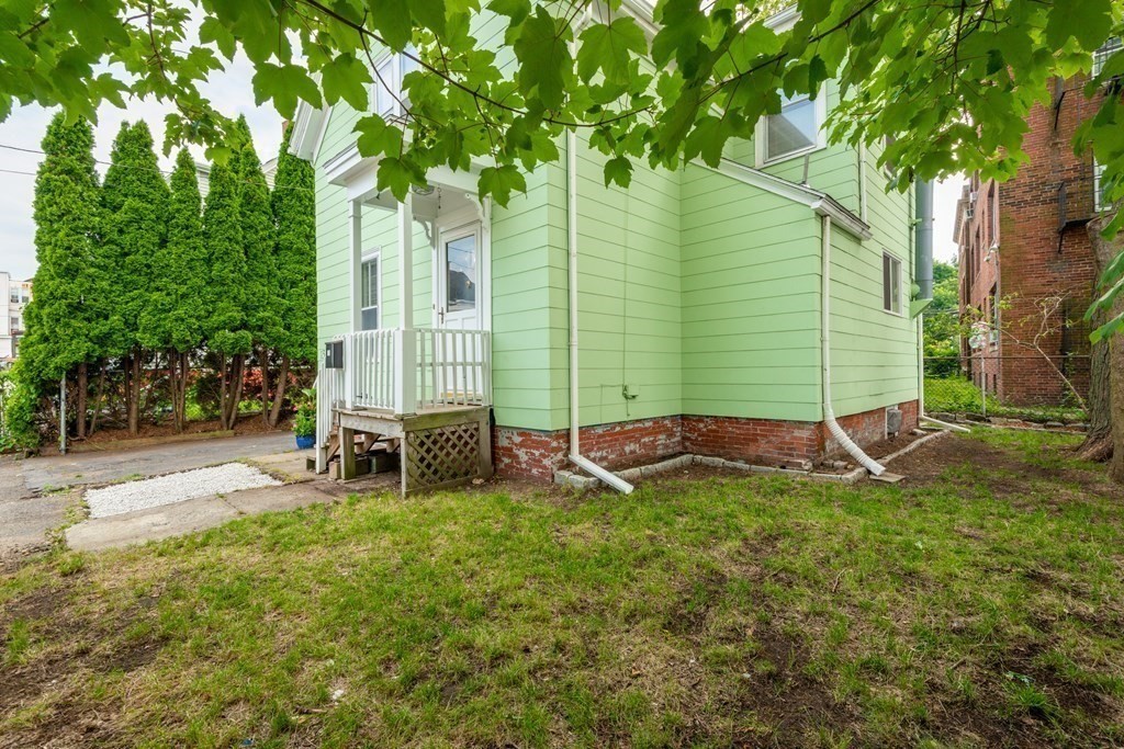 13 Melville Place Lynn, MA 01902 - Photo 40 of 41 a backyard of a house with table and chairs