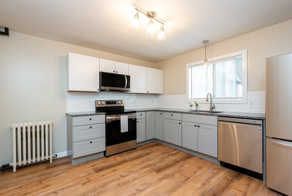 13 Melville Place Lynn, MA 01902 - Photo 6 of 41 a kitchen with granite countertop appliances cabinets and a sink