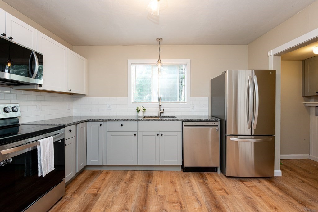 13 Melville Place Lynn, MA 01902 - Photo 9 of 41 a kitchen with a refrigerator stove and sink