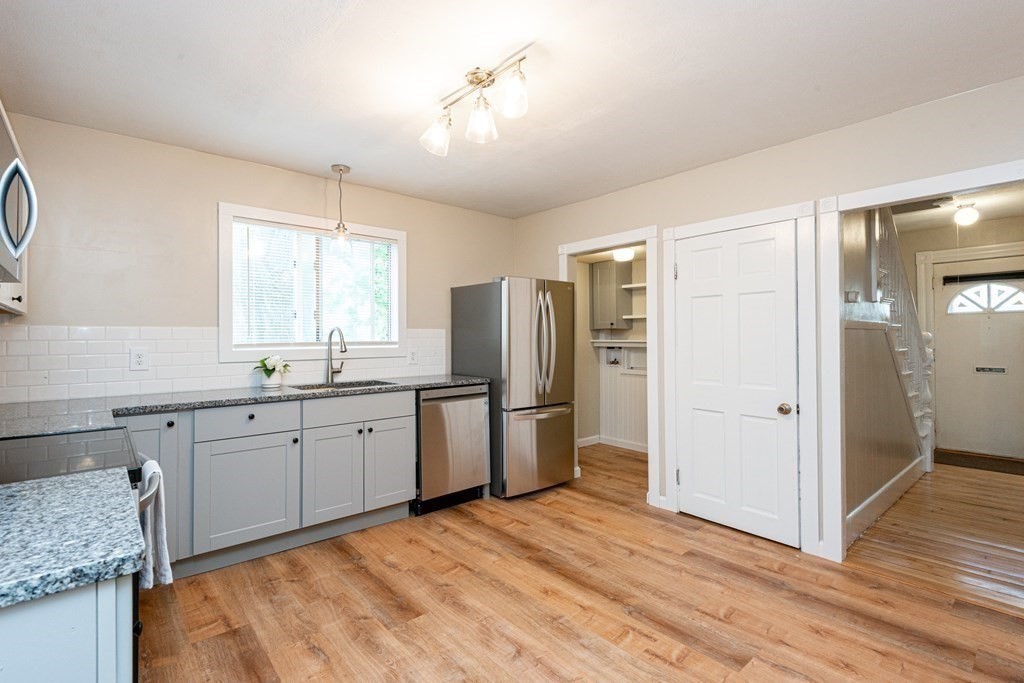 13 Melville Place Lynn, MA 01902 - Photo 10 of 41 a spacious bathroom with a granite countertop sink mirror and a refrigerator