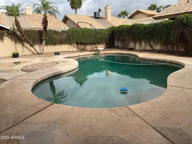 a view of a swimming pool with a outdoor seating
