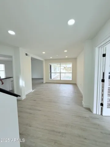 a view of empty room with wooden floor