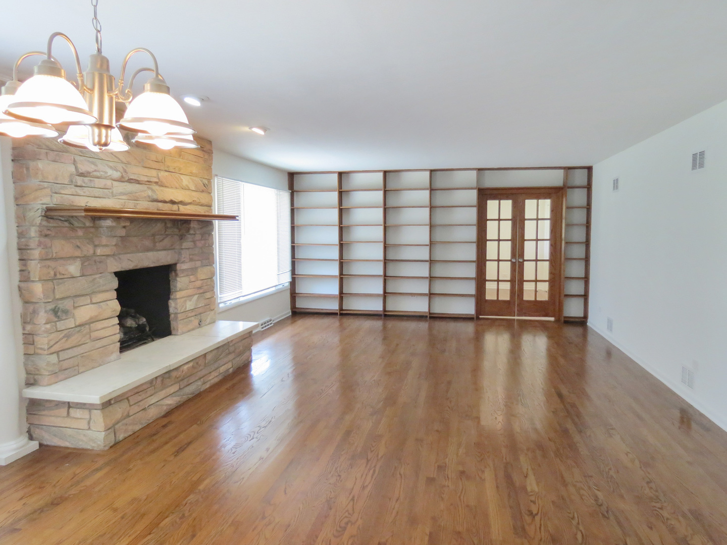 12970 McCarthy Road Lemont, IL 60439 - Photo 13 of 46 a view of an empty room with wooden floor fireplace and a window