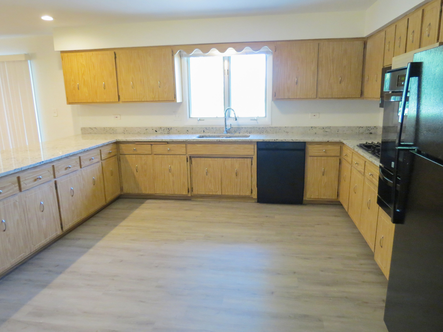 12970 McCarthy Road Lemont, IL 60439 - Photo 14 of 46 a kitchen with granite countertop a refrigerator sink and cabinets