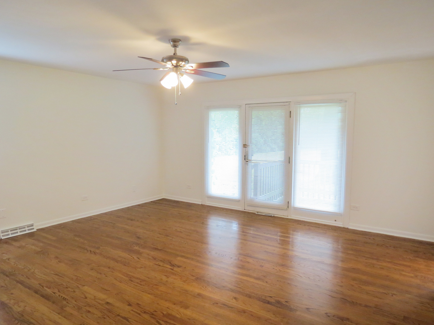12970 McCarthy Road Lemont, IL 60439 - Photo 22 of 46 a view of an empty room with wooden floor and a window