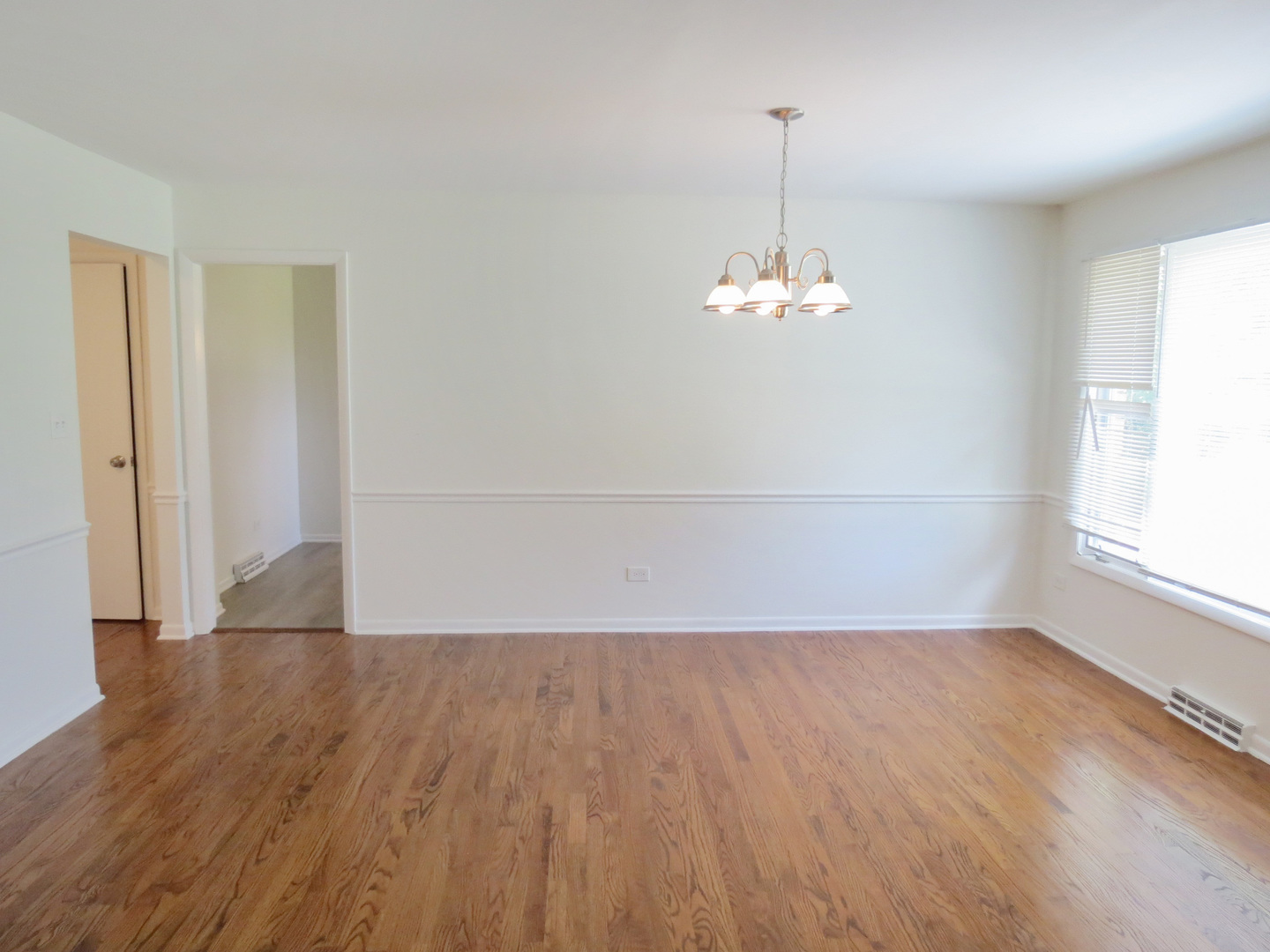 12970 McCarthy Road Lemont, IL 60439 - Photo 10 of 46 an empty room with wooden floor and windows