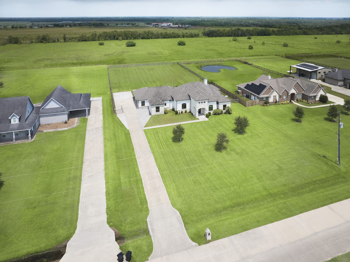 an aerial view of a house with a big yard