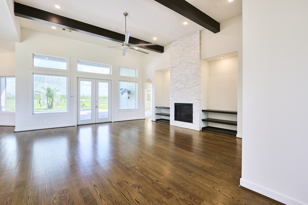 7911 Stratford Hall Drive Rosharon, TX 77583 - Photo 11 of 34 a view of an empty room with wooden floor and a window