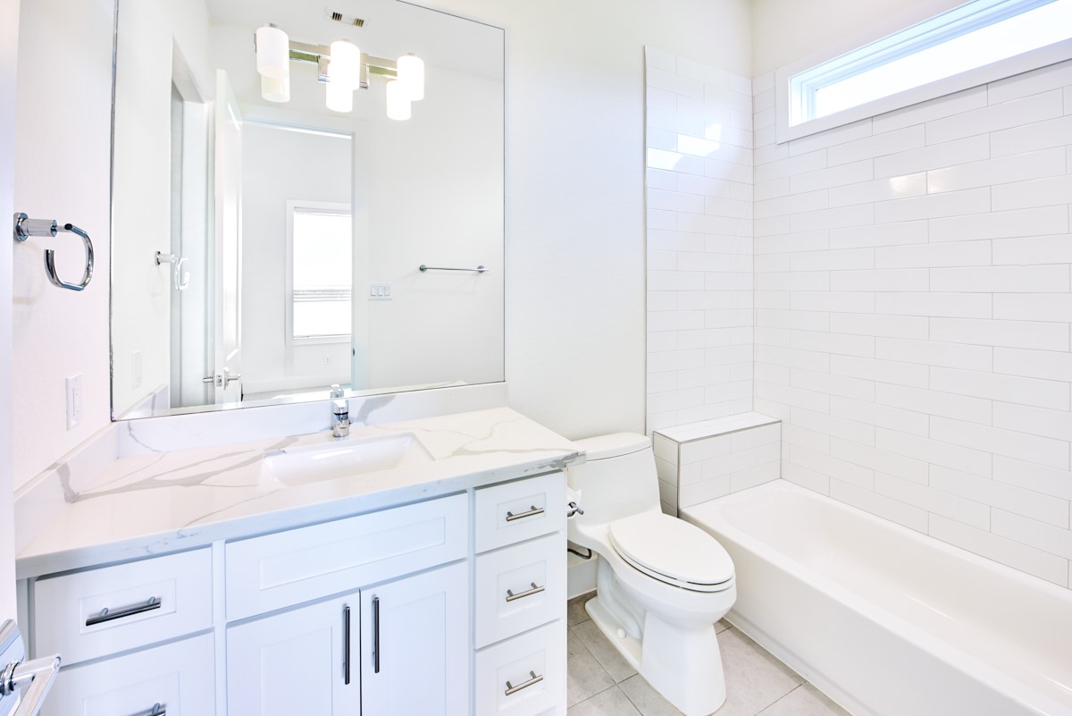 7911 Stratford Hall Drive Rosharon, TX 77583 - Photo 22 of 34 a bathroom with a sink a toilet and a large mirror