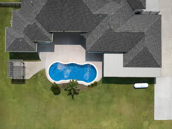 an aerial view of a house with outdoor space