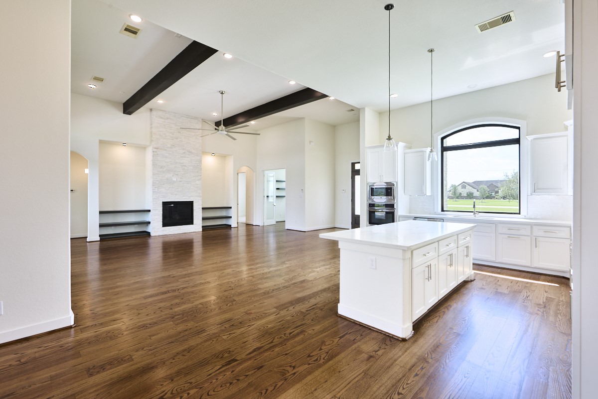 7911 Stratford Hall Drive Rosharon, TX 77583 - Photo 4 of 34 a large kitchen with a lot of counter space and wooden floor