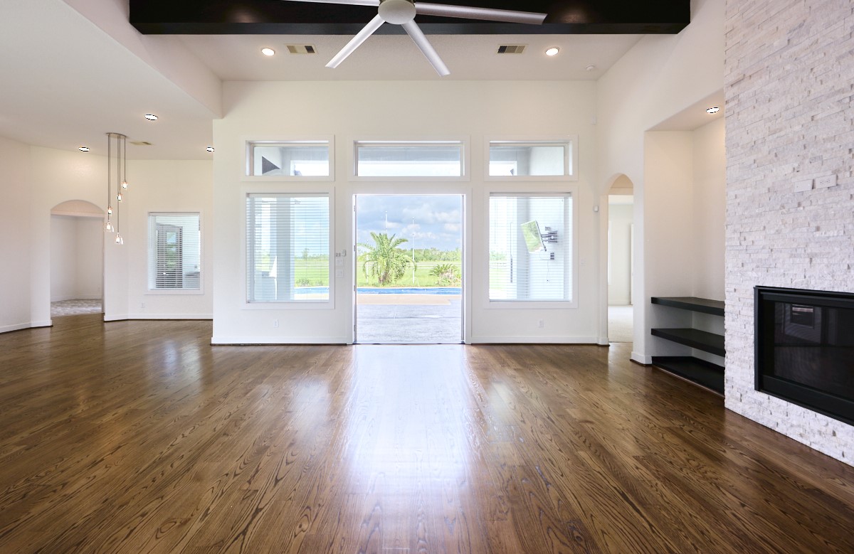 7911 Stratford Hall Drive Rosharon, TX 77583 - Photo 6 of 34 a view of an empty room with a window and wooden floor