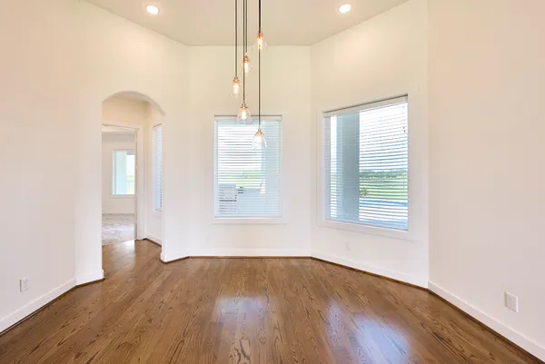 a large kitchen with cabinets and wooden floor