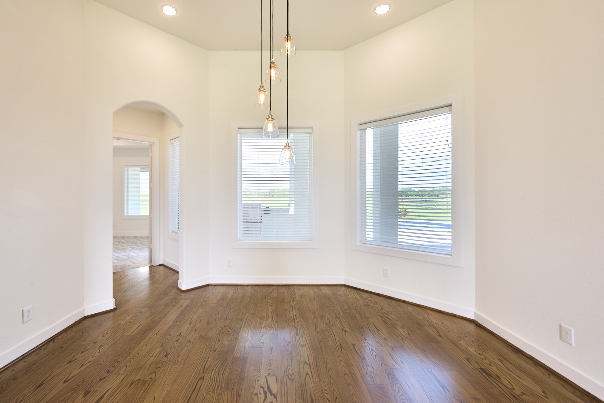 7911 Stratford Hall Drive Rosharon, TX 77583 - Photo 8 of 34 a view of an empty room with wooden floor and a window
