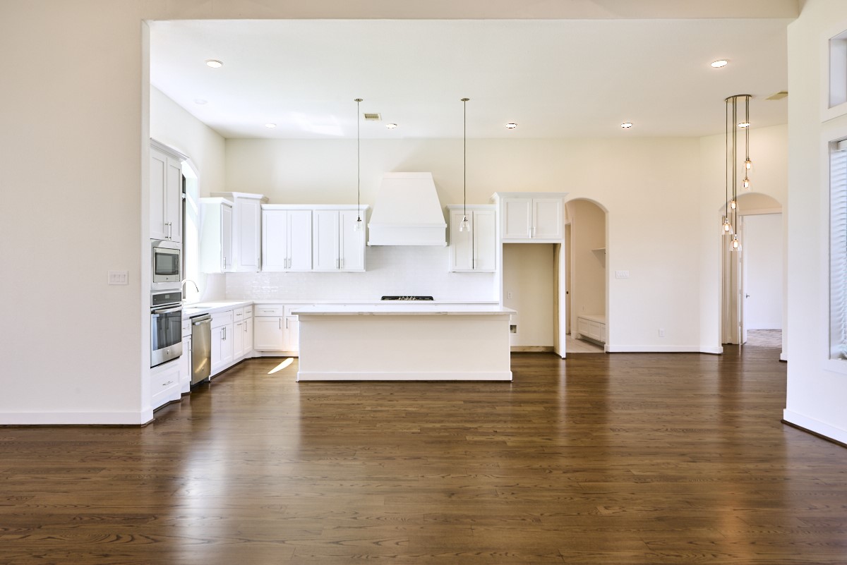 7911 Stratford Hall Drive Rosharon, TX 77583 - Photo 9 of 34 a large kitchen with cabinets and wooden floor