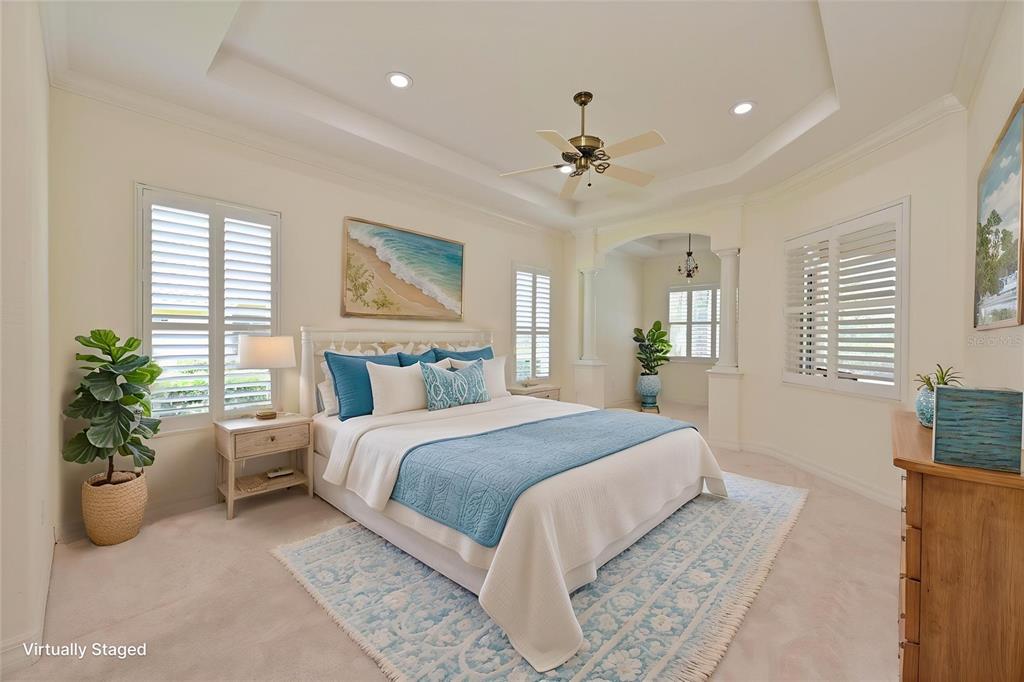 10622 Conch Shell Terrace Bradenton, FL 34212 - Photo 15 of 69 a spacious bedroom with a large bed a chandelier and a couch