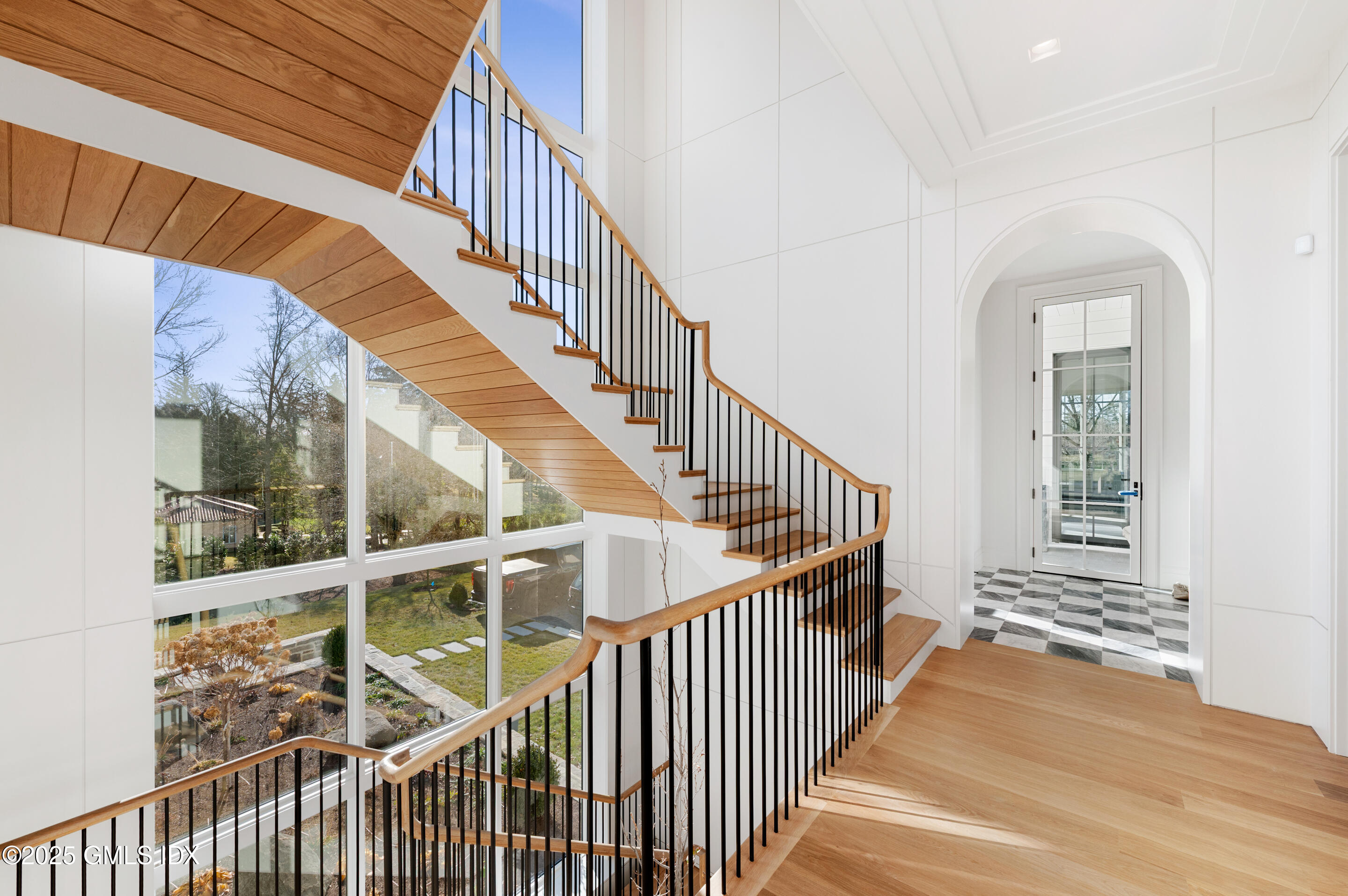 382 North Street Greenwich, CT 06830 - Photo 15 of 27 a view of staircase with lots of windows and wooden fence