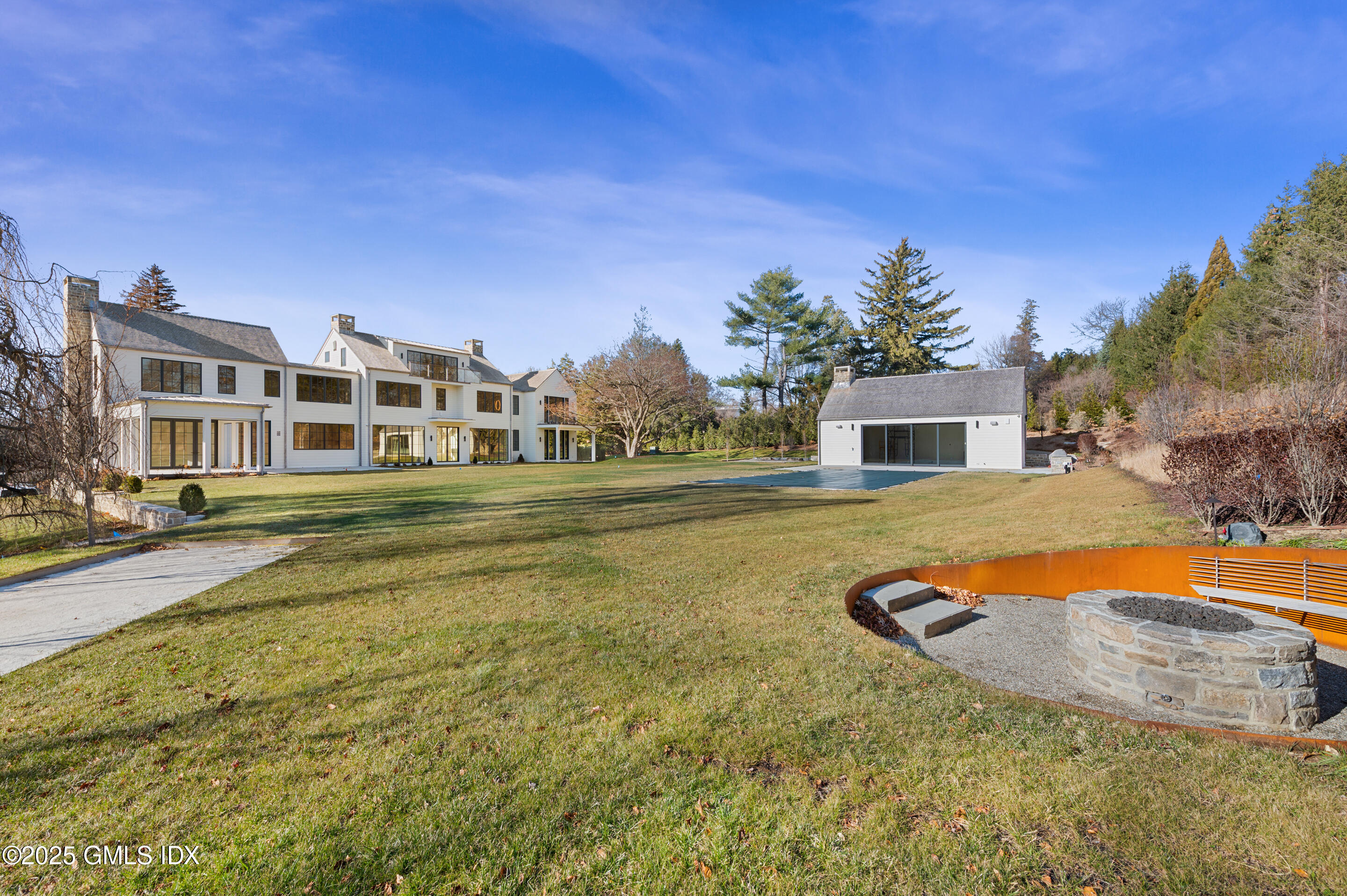 382 North Street Greenwich, CT 06830 - Photo 19 of 27 a swimming pool with outdoor seating and yard