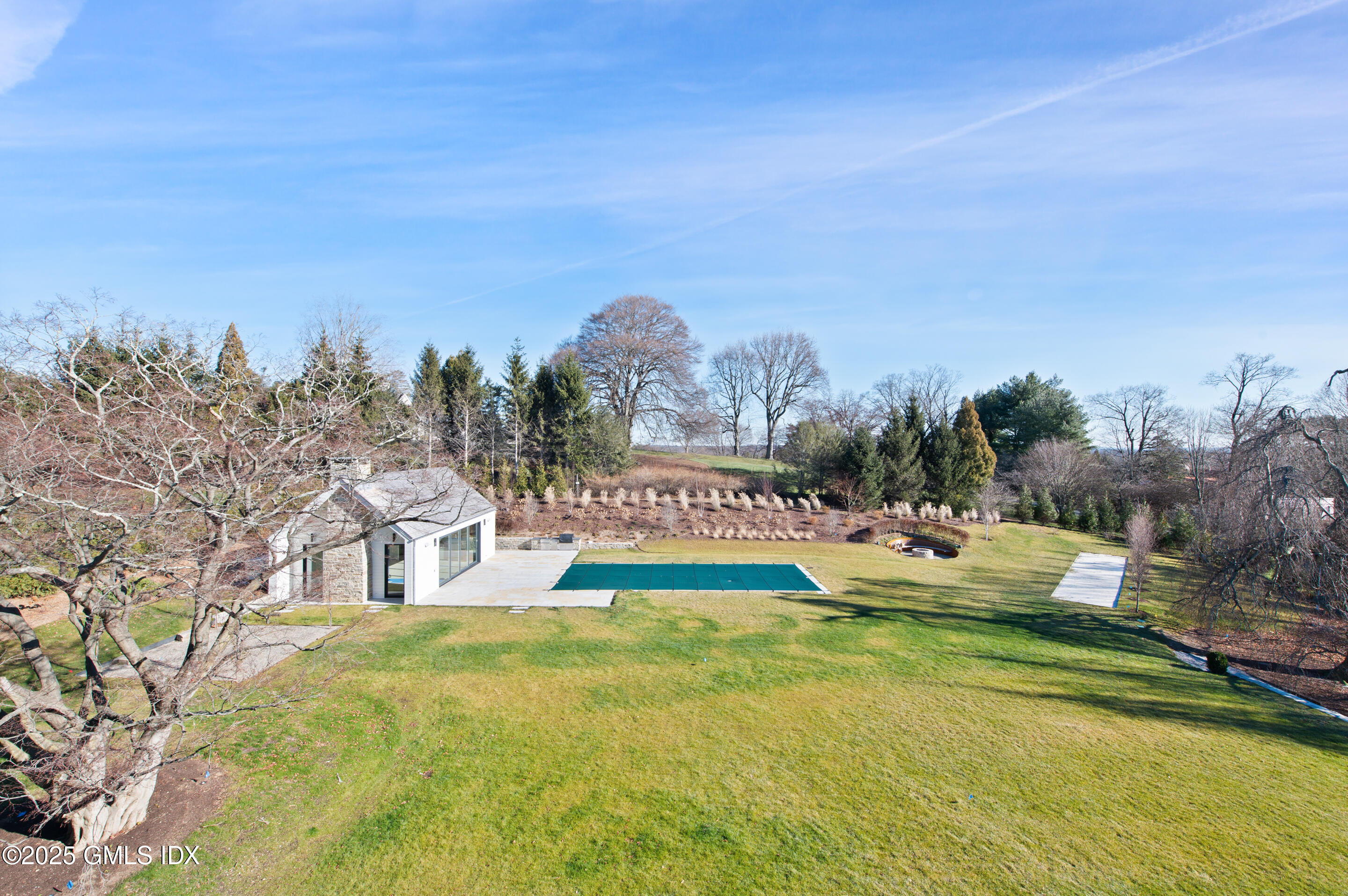 382 North Street Greenwich, CT 06830 - Photo 20 of 27 a view of swimming pool with trees and buildings in the background
