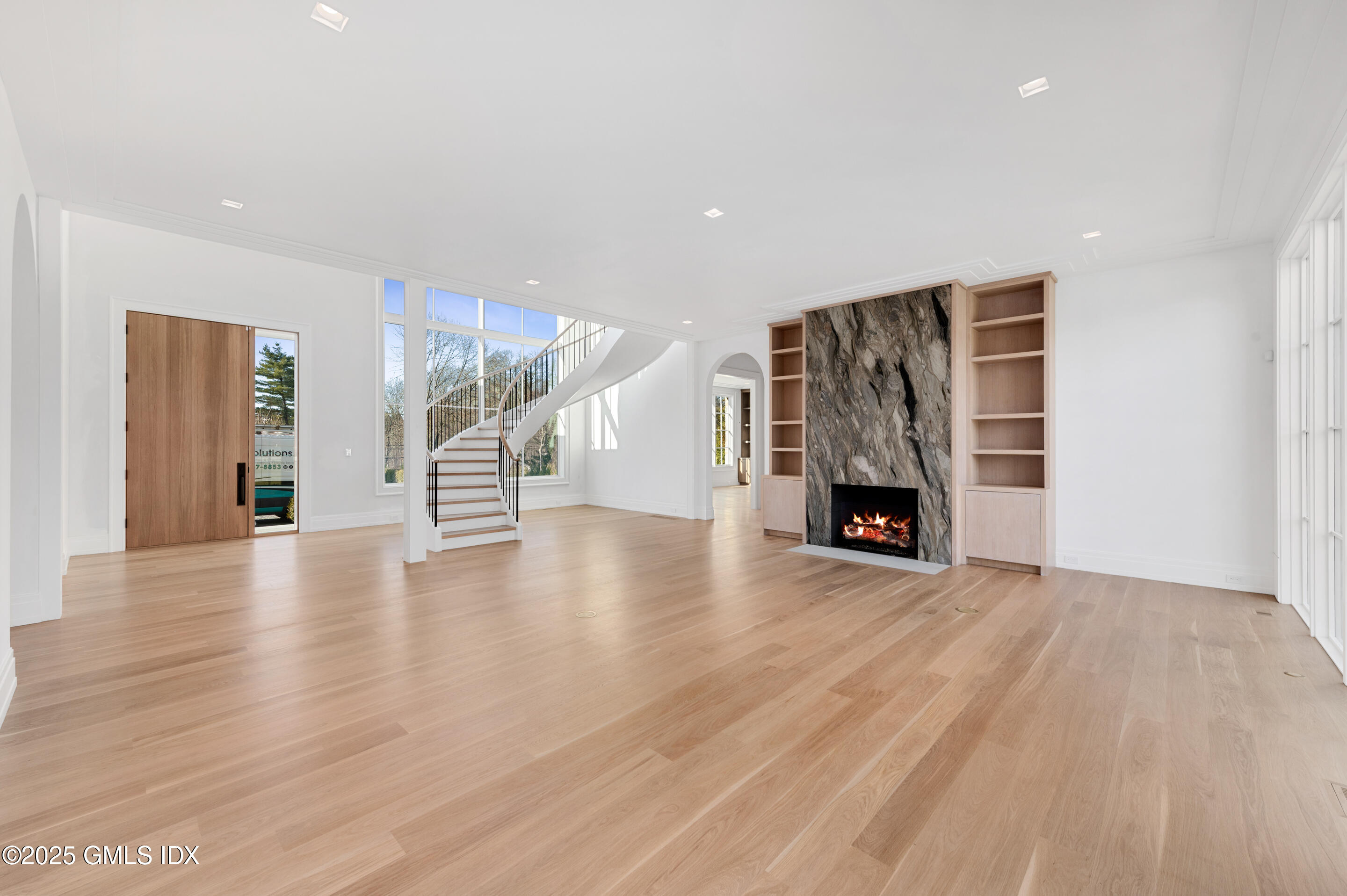 382 North Street Greenwich, CT 06830 - Photo 9 of 27 a view of an empty room with wooden floor fireplace and a window
