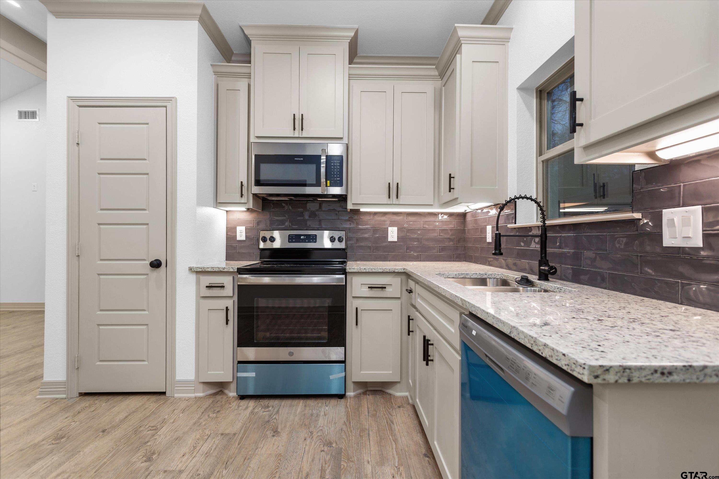 927 Nell Avenue Tyler, TX 75701 - Photo 11 of 20 a kitchen with a sink and a stove top oven