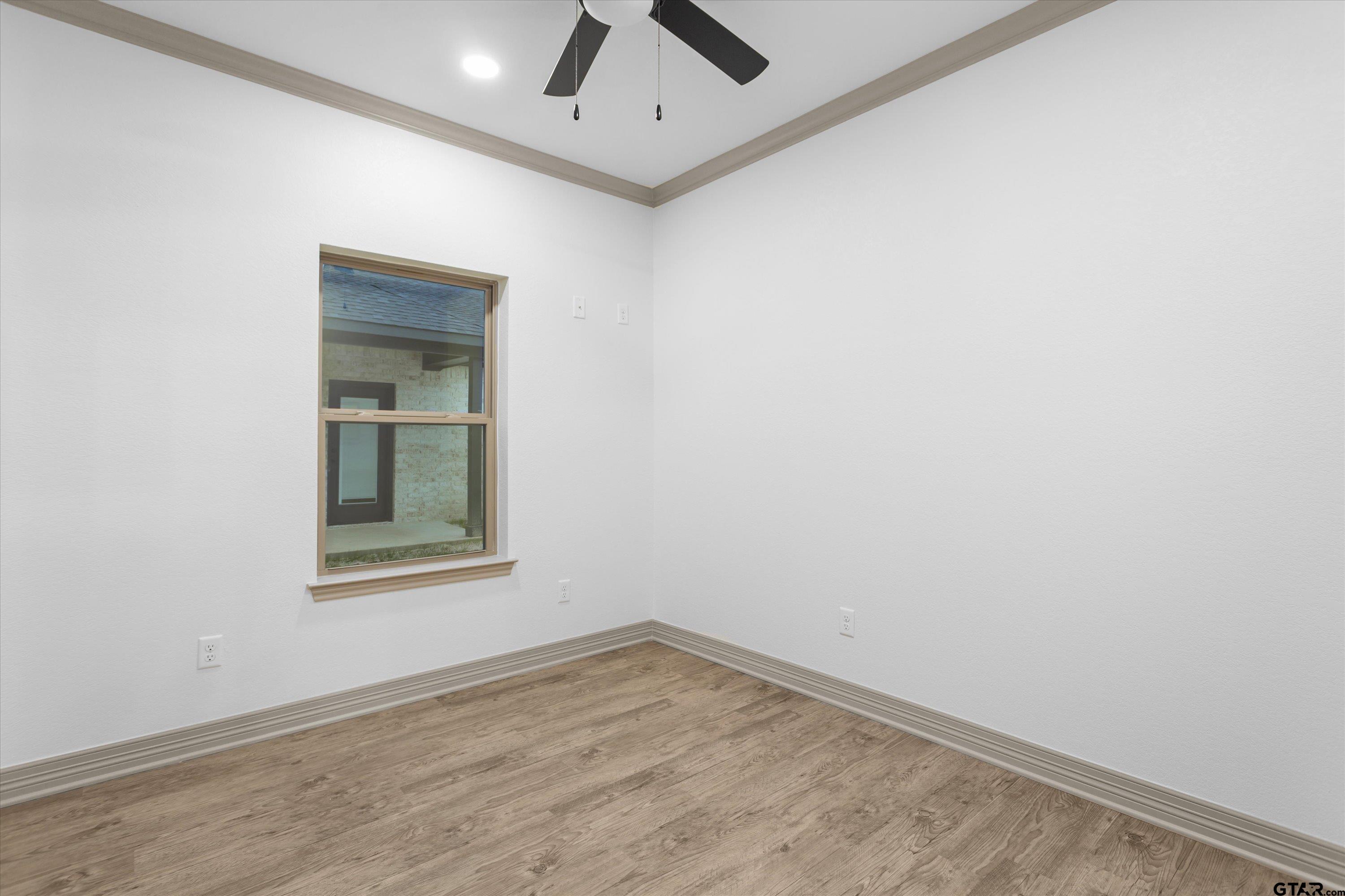 927 Nell Avenue Tyler, TX 75701 - Photo 15 of 20 an empty room with a window and ceiling fan