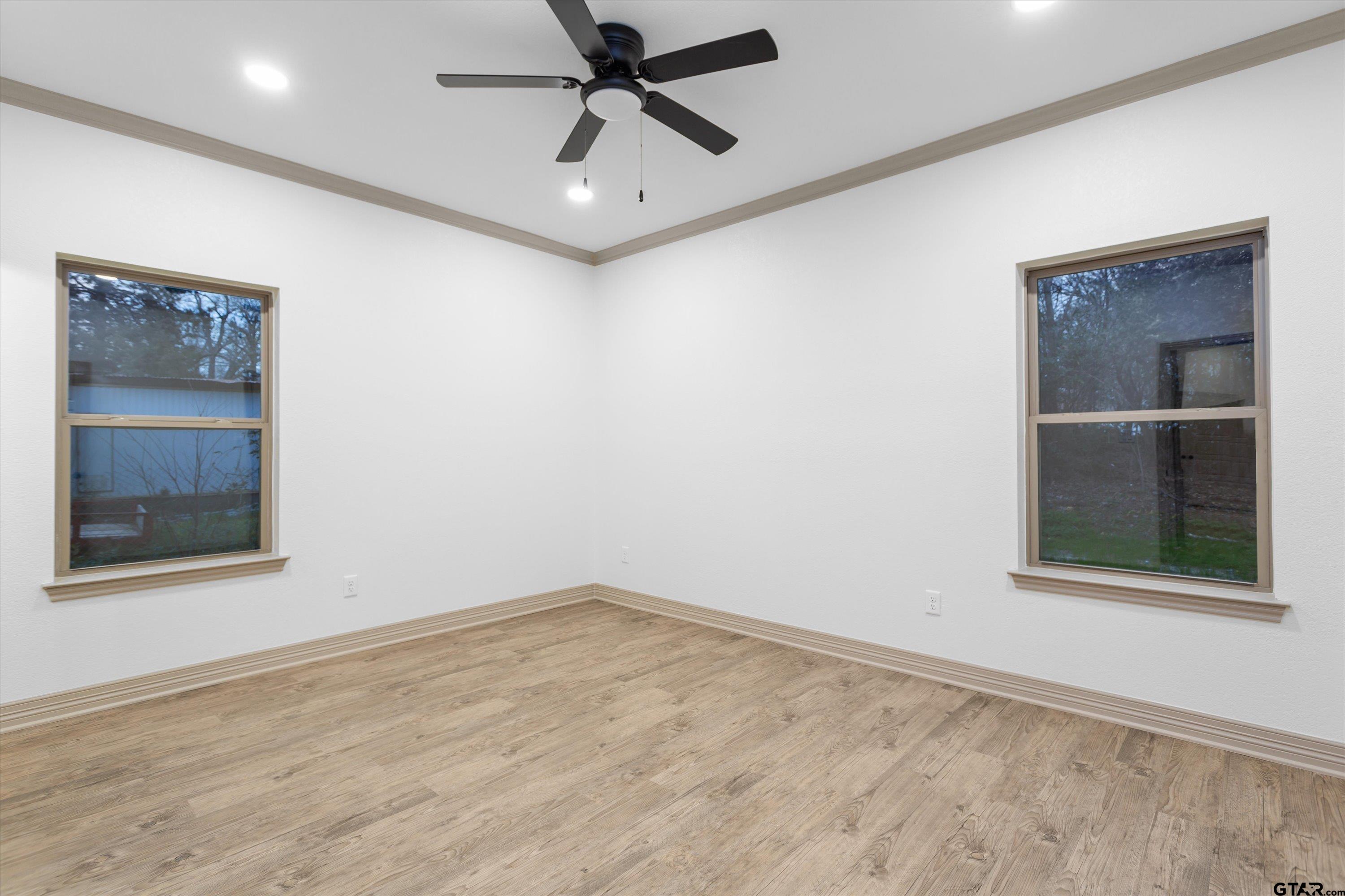927 Nell Avenue Tyler, TX 75701 - Photo 19 of 20 an empty room with a window and a ceiling fan