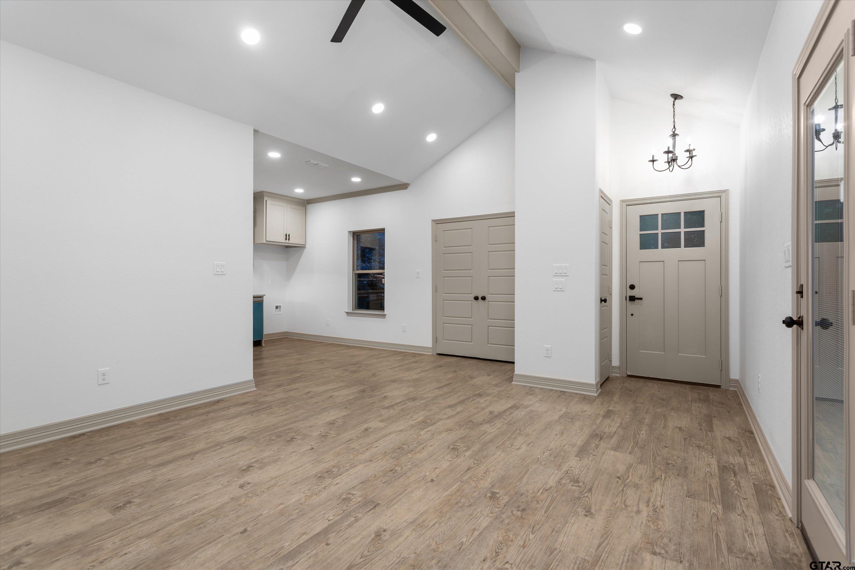 927 Nell Avenue Tyler, TX 75701 - Photo 7 of 20 an empty room with wooden floor and windows