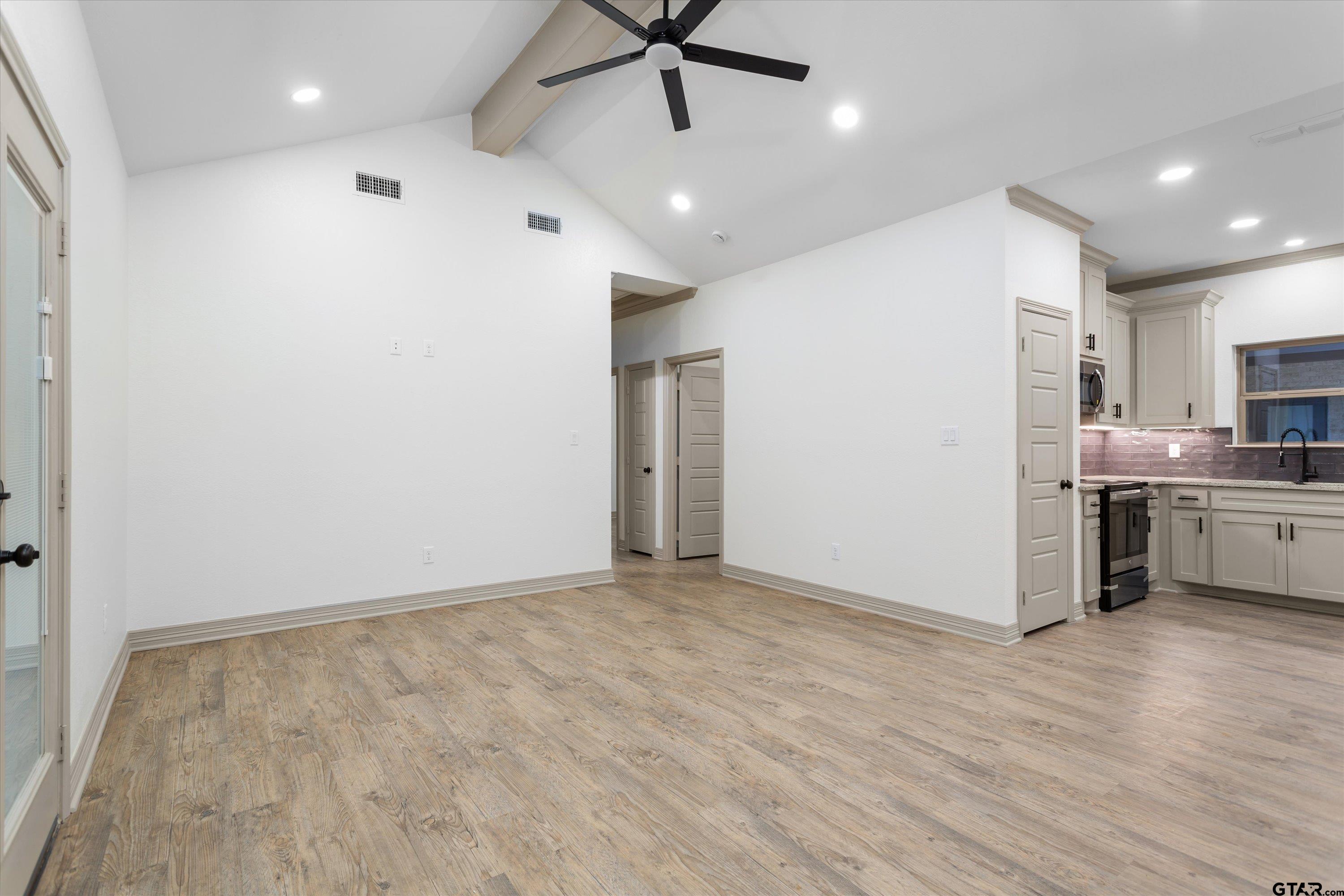 927 Nell Avenue Tyler, TX 75701 - Photo 8 of 20 a view of a kitchen with a sink and a refrigerator