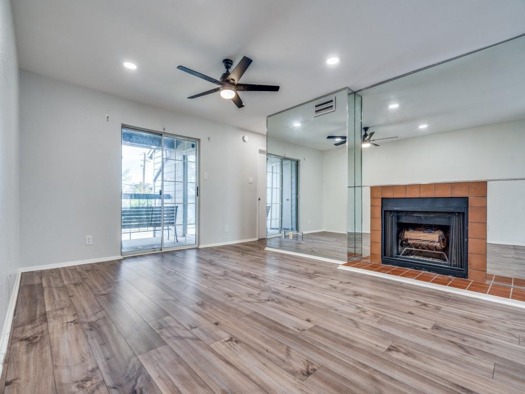 12480 Abrams Road, Unit 3023 Dallas, TX 75243 - Photo 1 of 1 a view of an empty room with a fireplace and a window